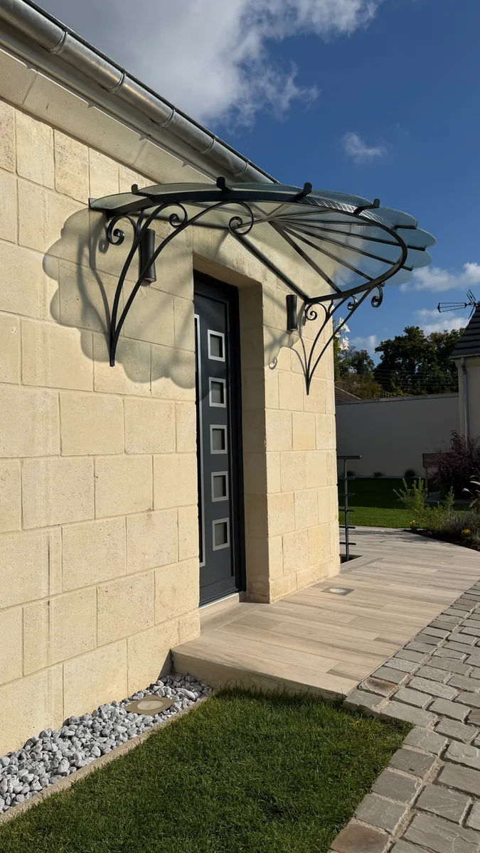 Marquise en fer forgé et verre au-dessus d'une porte d'entrée avec perron, L'Art de Faire