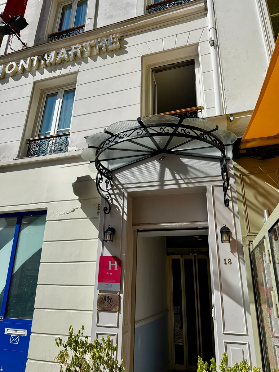 Marquise en fer forgé au-dessus de l'entrée d'un bâtiment, L'Art de Faire