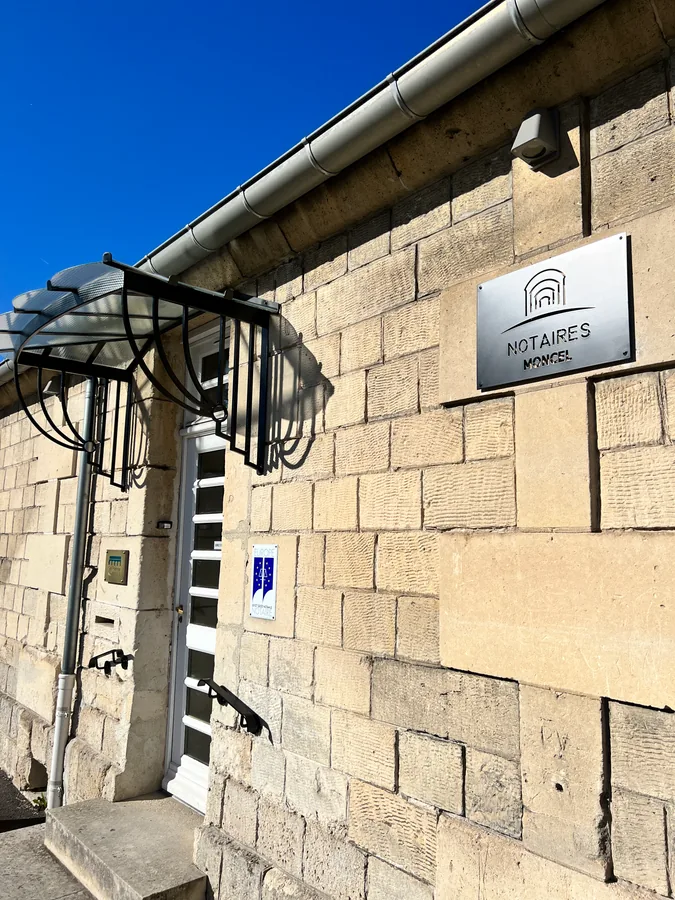 Auvent vitré en fer forgé le long d'une façade en pierre, L'Art de Faire