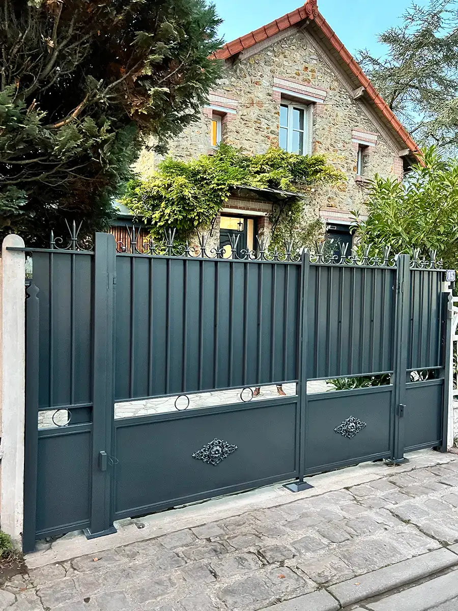 Portail coulissant plein en fer forgé anthracite à frises d'anneaux et médaillons, maison en meulière, L'Art de Faire